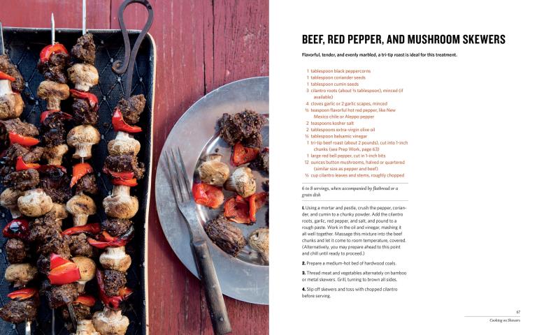 Beef, red pepper, and mushroom skewers on a tray with a recipe card on the side.