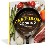 Book cover of 'Cast-Iron Cooking' with a cast-iron skillet, vegetables, and meat on a wooden surface.