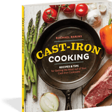 Book cover of 'Cast-Iron Cooking' with a cast-iron skillet, vegetables, and meat on a wooden surface.