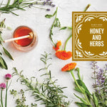 Honey and herbs on a textured surface with a book titled 'Honey and Herbs'.