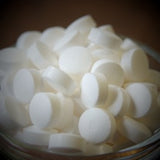 A glass bowl filled with tablets
