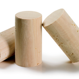 Three wooden wine bottle corks on a white background