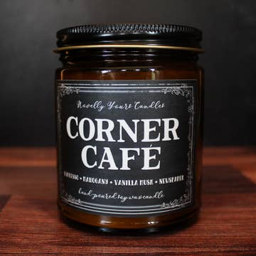 Candle jar labeled 'Corner Cafe' on a wooden surface with a dark background