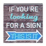 wooden block with saying "if you're looking for a sign this is it" on a clear background