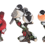 Set of three decorative bird figurines on branches with flowers against a white background