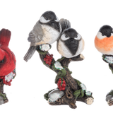 Set of three decorative bird figurines on branches with flowers against a white background