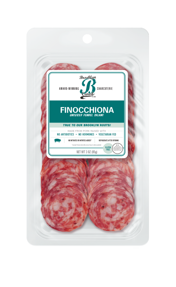 Package of cured meats with a green branded label on a white background