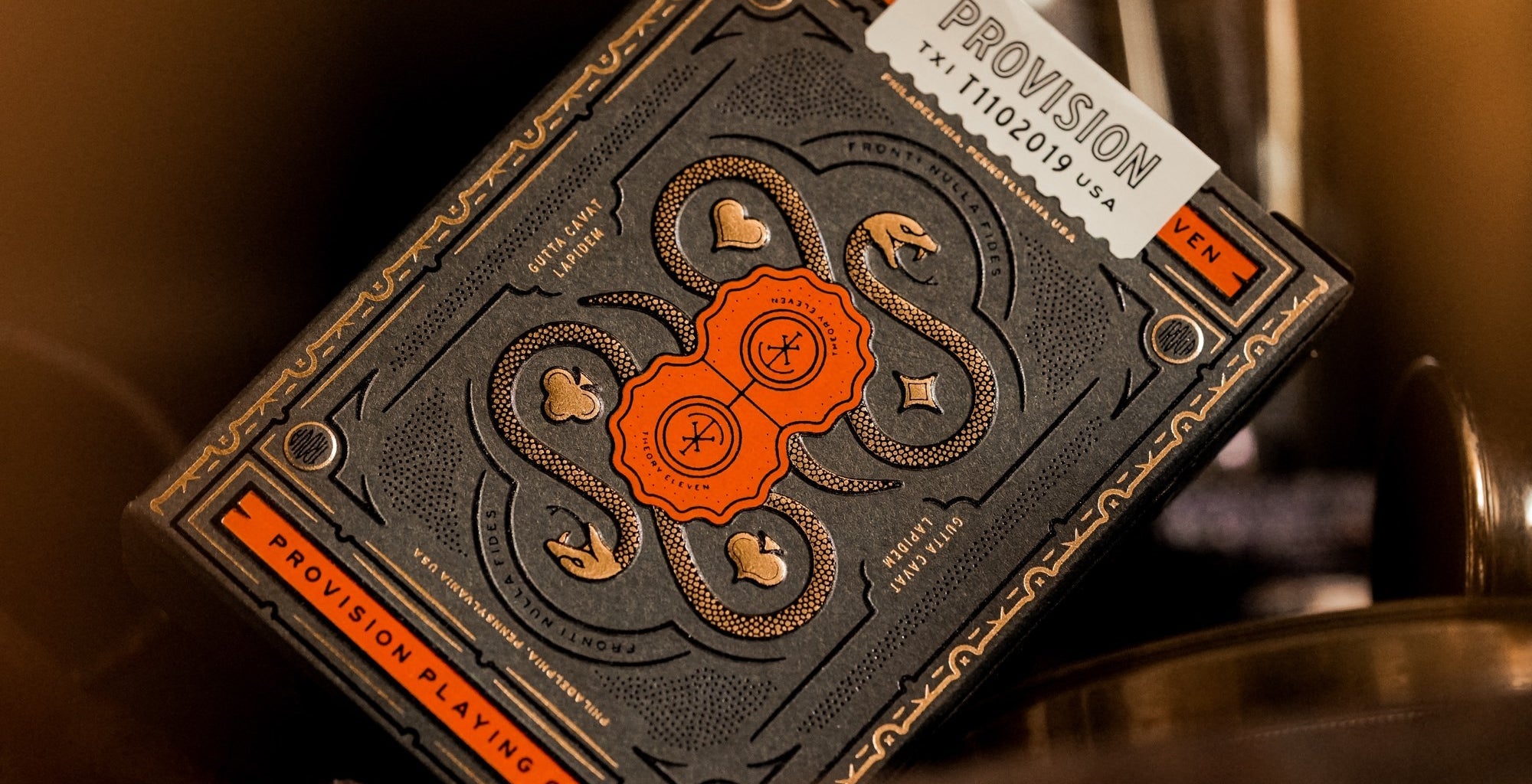 Playing card deck with intricate design and 'Provision' branding on a blurred background