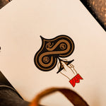Playing card with ace of spades on a wooden surface