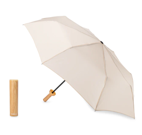 Beige umbrella with wooden look handle on a white background