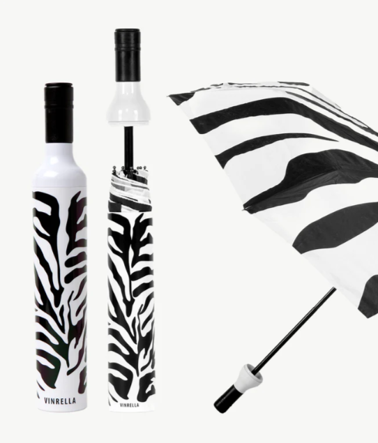 Zebra-patterned umbrella with white handle and base, displayed open and closed.
