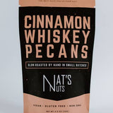 Bag of cinnamon whiskey pecans with 'Nat's Nuts' branding on a light gray background
