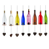 Colorful glass bottle wind chimes with cork stoppers and heart-shaped weights on a white background