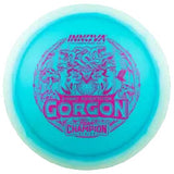 Blue disc golf disc with 'Gorgon' and 'Champion' branding on a transparent background