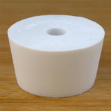 White rubber bottle stopper with hole on a wooden background