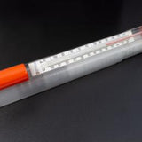 Bottle thermometer with orange handle on a black background