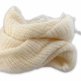White knitted muslin bag wound up on a white background