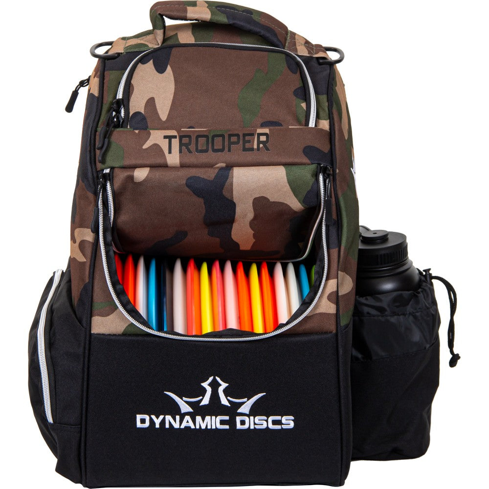 Camouflage backpack with colorful discs and Dynamic Discs branding on a white background