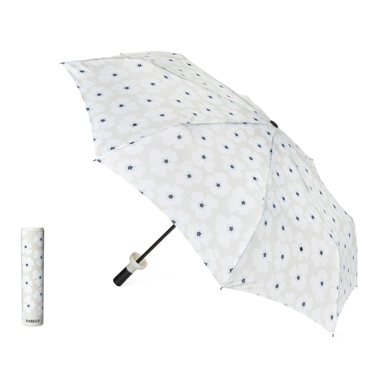 Grey umbrella with white flowers and black centers and matching handle on a white background