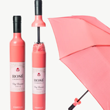 Pink rose-shaped umbrella with bottle design on a white background