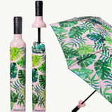 Tropical leaf patterned umbrella with pink handle and frame on a white background